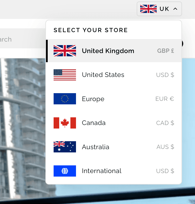 The in-house region switcher open, listing United Kingdom, United States, Europe, Canada, Australia and International, each with its currency.